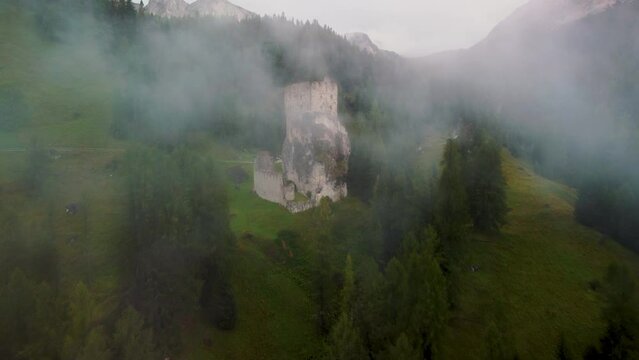 Old castle ruins in the fog, north of Italy, Castello di Andraz.