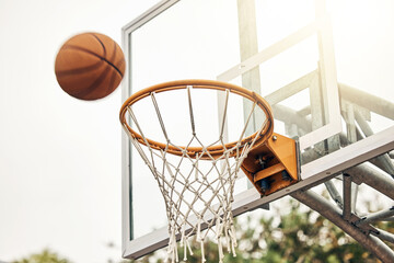 Basketball, net and ball flight in sports game outdoors for match in the USA. Sport and airball of throw to score point for win, victory against fiberglass board outside in a urban town or courtyard
