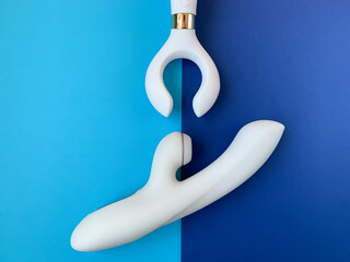 Sex shop assortment. Two white vibrators on blue background. Useful for adult