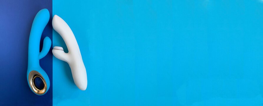 Banner. Sex shop assortment. Two vibrators on blue background. Useful for adult. Copy space
