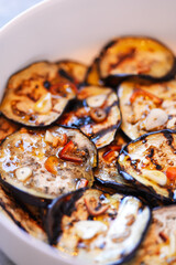 Tasty Italian homemade dish during autumn season, made of grilled eggplant, garlic, hot pepper and olives oil. Traditional Italian recipes.