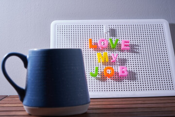 i love my job message and cup of coffee on letter board