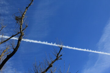 Contrails from airplane in blue sky