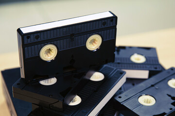 Pile of video cassette tape VHS on video playback stack concept of old retro style or vintage...