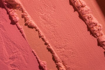 Blusher or pressed powder pink orange peach textured background	