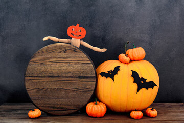 Wood round sign Halloween mockup with funny wood people and many pumpkins, bats on old wooden table...