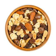 Nut chocolate mix, in a wooden bowl. Sweet snack food and mixture of raisins, roasted peanuts and almonds, with milk chocolate dipped roasted peanuts, and white chocolate covered corn flakes. Close up