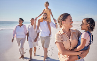 Mother and child on holiday by the beach with grandparents taking a walk together. A happy big...