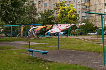 Laundry dries on a line in the courtyard of a residential area. Horishni Plavni city, Ukraine