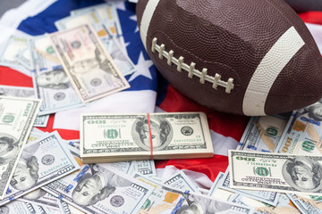 Money and rugby ball on american flag background, closeup. Concept of sports bet