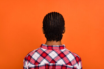 Fototapeta na wymiar Rear back portrait of young lady fresh news dreadlocks braids hairdo isolated on orange color background