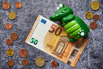 50 euros and a crocodile, predatory capitalism - obrazy, fototapety, plakaty