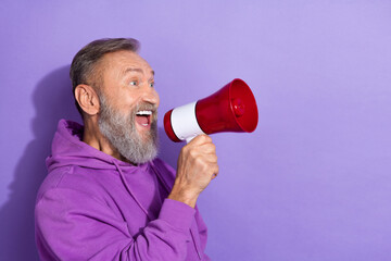 Photo of pensioner man with white gray hair dressed purple hoodie loud screaming in megaphone...