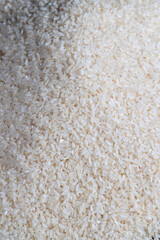 a pile of scattered white rice on the kitchen table