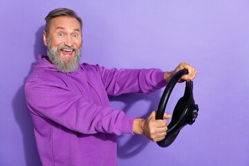 Portrait of unbelievable unexpected staring man wear purple hoodie hold steering wheel test new car...