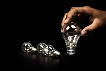 Close up hand choose light bulb or lamp for human resources or leadership and creativity thinking idea motivation or vision and knowledge learning and study or education concept.