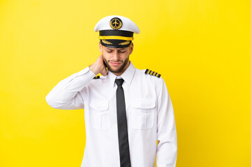 Airplane caucasian pilot isolated on yellow background with neckache