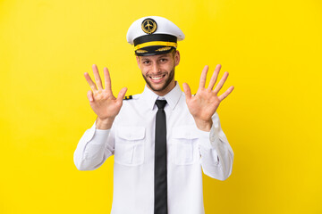 Airplane caucasian pilot isolated on yellow background counting nine with fingers