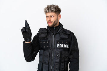 SWAT caucasian man isolated on white background with fingers crossing and wishing the best