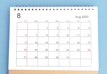 close-up of calendar August month of 2023 on a blue background - obrazy, fototapety, plakaty