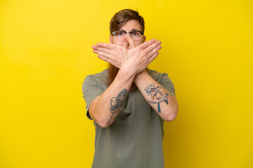 Fototapeta premium Redhead man with beard isolated on yellow background making stop gesture with her hand to stop an act