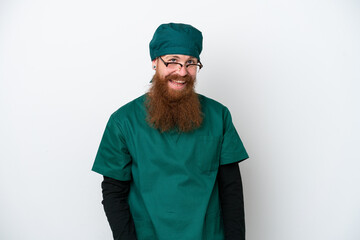 Surgeon redhead man in green uniform isolated on white background with glasses and surprised