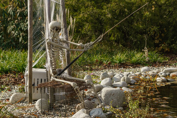 Halloween - fishing skeleton by the pond