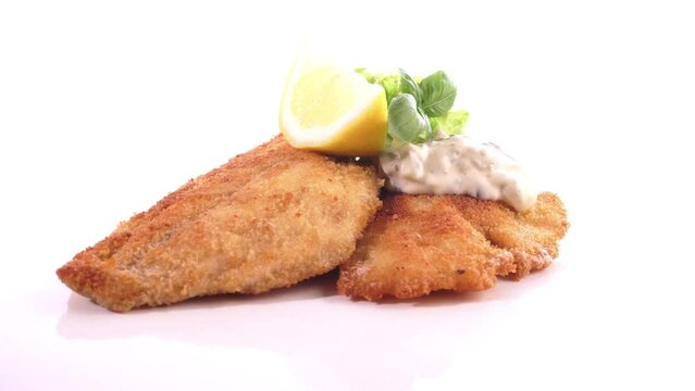 Fried Fish Fillet with Lemon - Food on a turntable isolated on white background