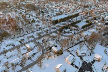 The small town in New Jersey where the residential housing complexes are located has snow coverings on roofs after severe snowstorm hit the area