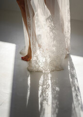 The legs of a girl and a delicate dress swirling in the light.
Selective focus.