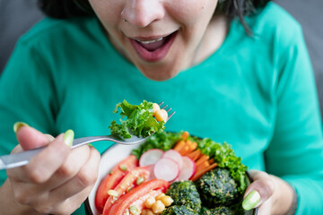 Woman eating vegan food. Plant based, cruelty free food concept. Close up