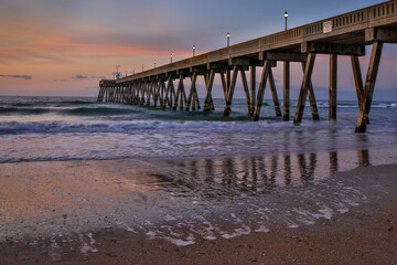 North Carolina beach pier with reflections at sunrise