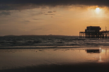 California pier with stormy sunset