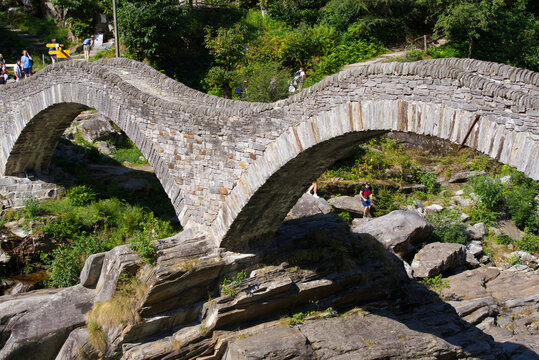 Beautiful old double arc stone bridge at village Lavertezzo, Canton Ticino, on a sunny summer day. Photo taken July 26th, 2022, Lavertezzo, Switzerland.
