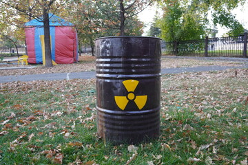 black iron barrel with dangerous radiation sign