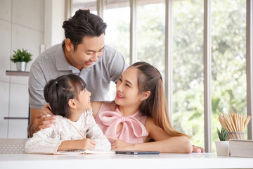 Real estate and mortgage concept : Family with child having activity in new home. Joyful first-time buyers in living room. Real estate, residential mortgage, moving into dream house.