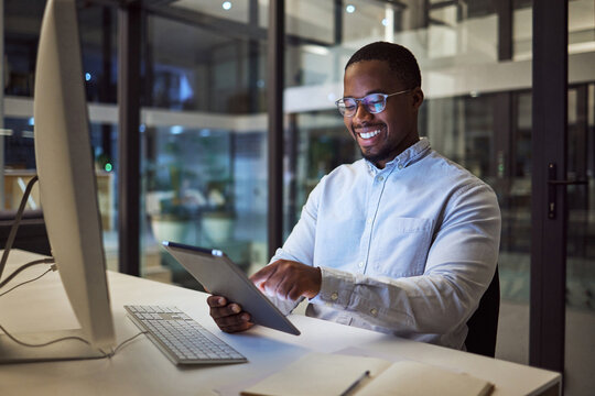 Businessman Working On Digital Tablet Late In Office At Night, Happy And Inspired By Career Goal. Motivation, Management And Vision By Black Entrepreneur Excited By Innovation And New Company