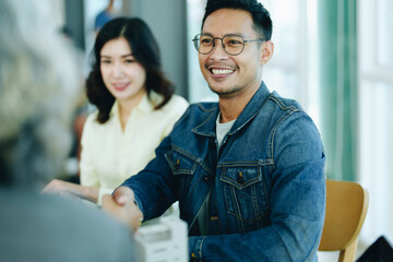 The bank's Mortgage Officers shake hands with customers to congratulate them after signing a housing investment loan agreement
