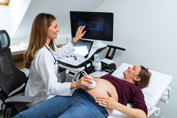 Expectant mother doing ultrasound scan in the prenatal clinic. Gynecology examination and consultation.
