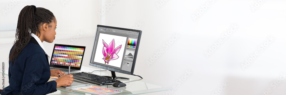 Poster designer editing photos on computer