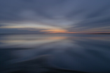 Fototapeta na wymiar Intentional camera movement on a lake during sunset.