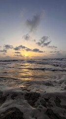 sunset at sea, white waves and variety of colors