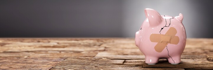 Broken Pink Piggybank With Bandage
