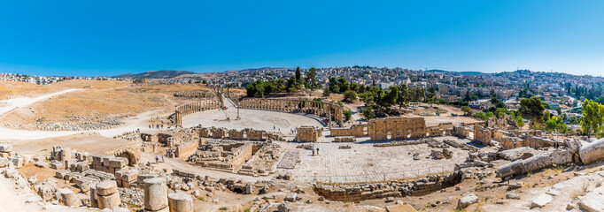 An aerial view across the ancient Roman settlement of Gerasa in Jerash, Jordan in summertime