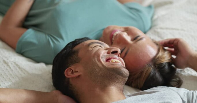Happy people in bedroom, couple talking of love and marriage bonding happiness in Mexico home. Indian man joke with girlfriend on bed, relax in hotel together and young asian woman laughing smile