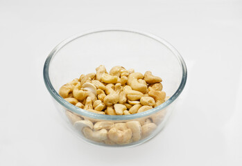 roasted cashews nuts in a transparent glass bowl closeup