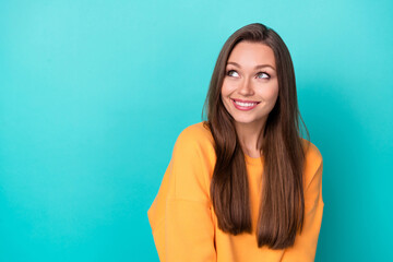 Photo of young attractive adorable pretty lady wear yellow stylish sweatshirt toothy smile look dreamy new product isolated on aquamarine color background