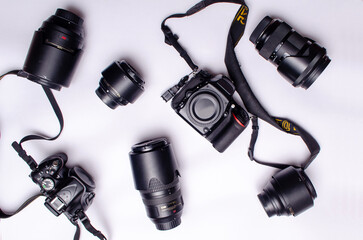 Camera lens and body are scattered on white background