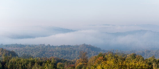 Morning fog overflow over the hill in autumn, rural landscape panorama in autumn season