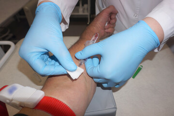 Taking blood from a patient's vein for analysis.